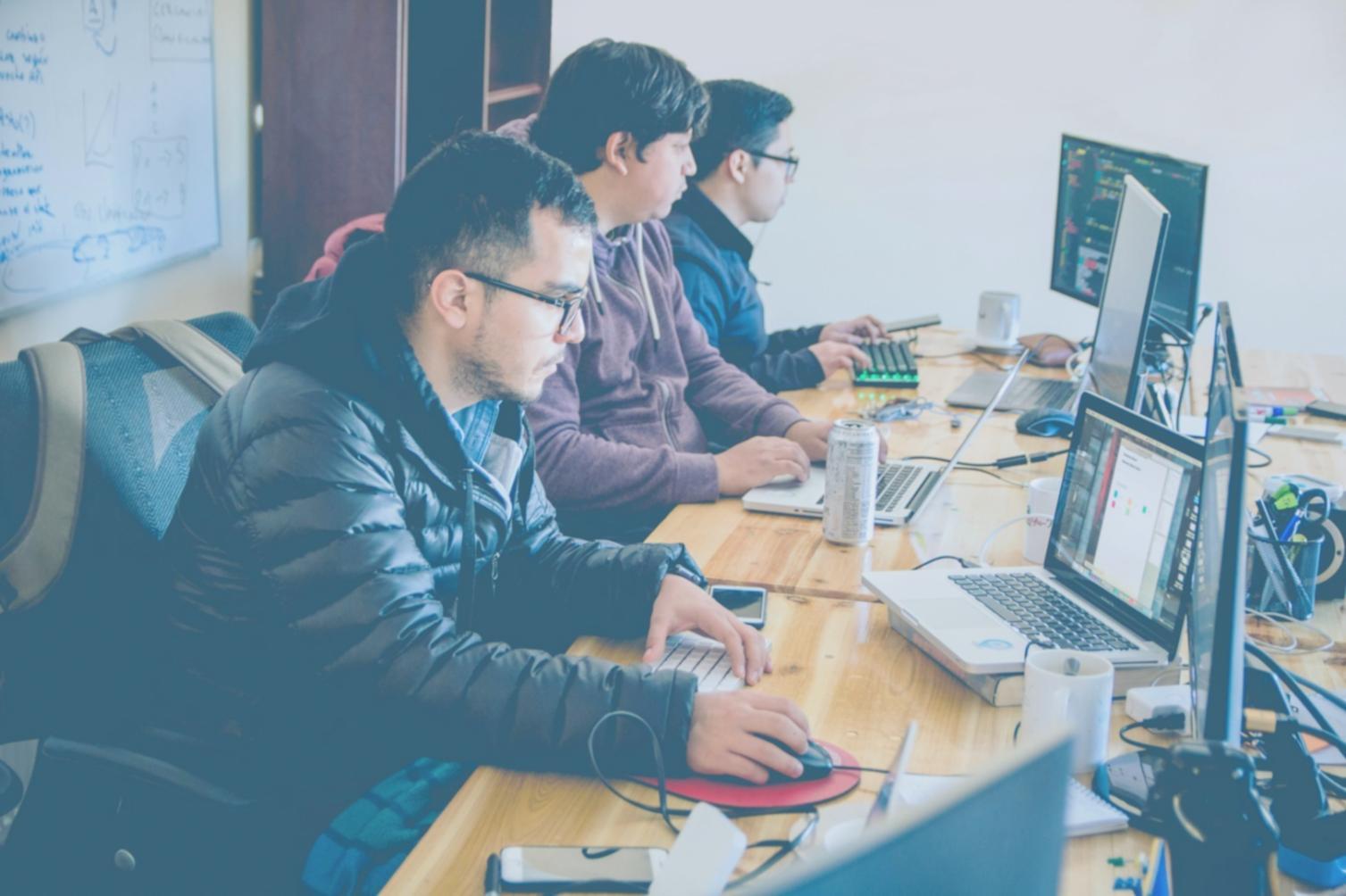 Students collaborating on smart contract development during hands-on training session