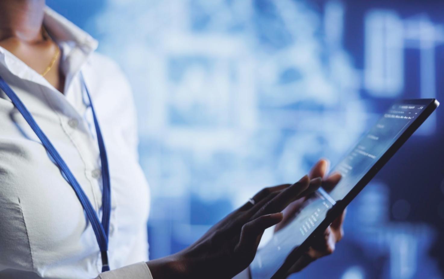 Instructor reviewing smart contract code architecture on multiple screens during training